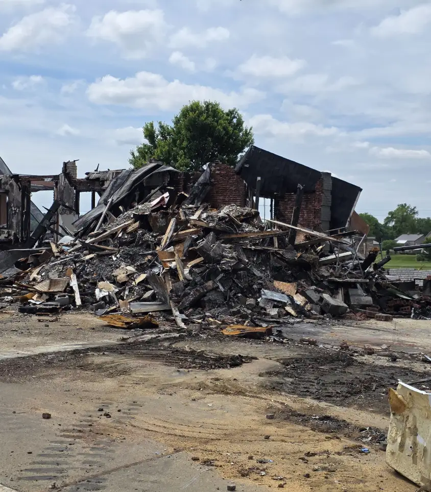 Fire-damaged house debris before cleanup
