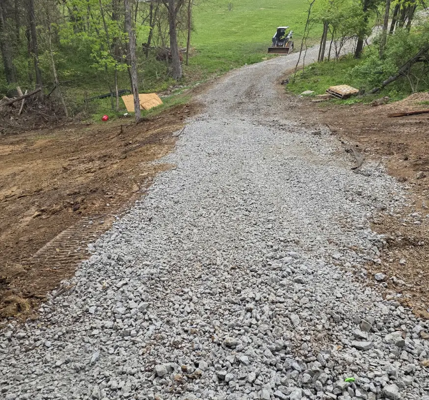 Gravel drive cut through the woods to a new home site