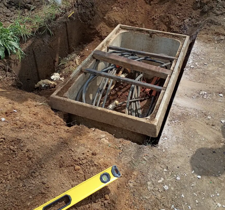 Utility vault set in a trench with a level